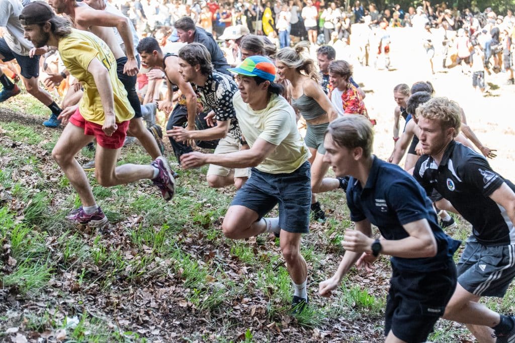 A group of adults running uphill in the uphill competition.