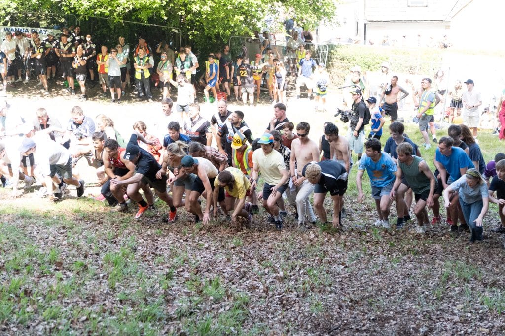 Racers getting ready to race up the hill, but half of them are in blown out light and half of the are normal.
