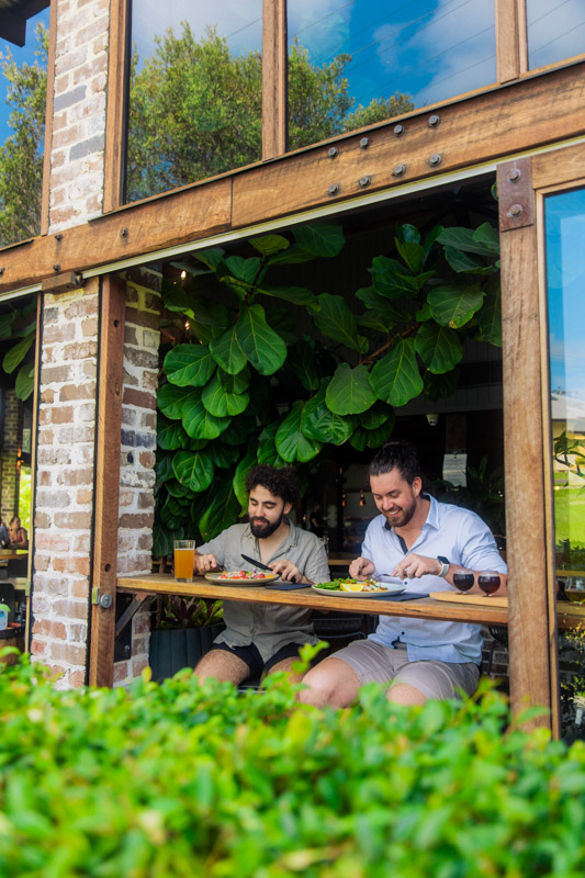 Friends enjoying a meal and drink at Copperhead Restaurant Brewery