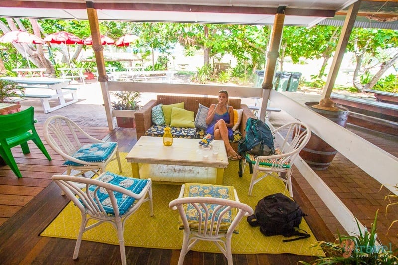 person sitting on couch in a relaxed setting with water views.