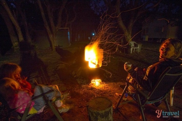 family sitting around firepit
