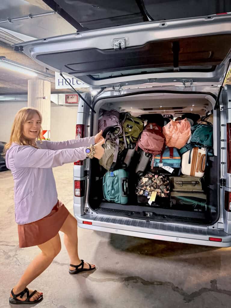 woman with van packed with luggage