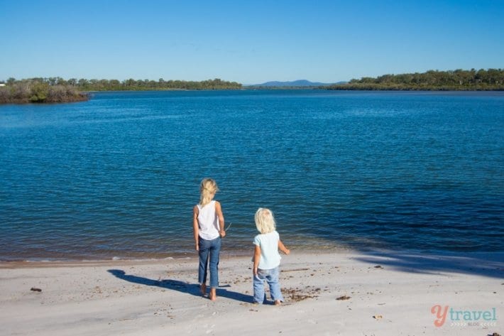 two girls standing beside Baffle Creek,
