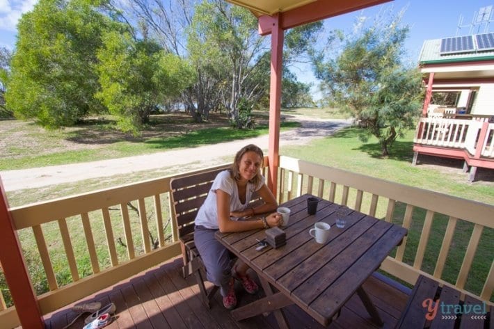lady sitting at table on deck of cabin