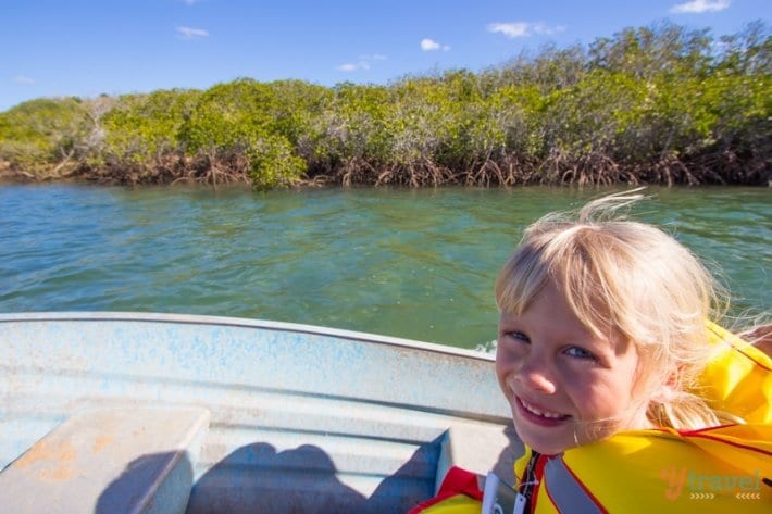 girl wearing a life jacket sitting on a boat