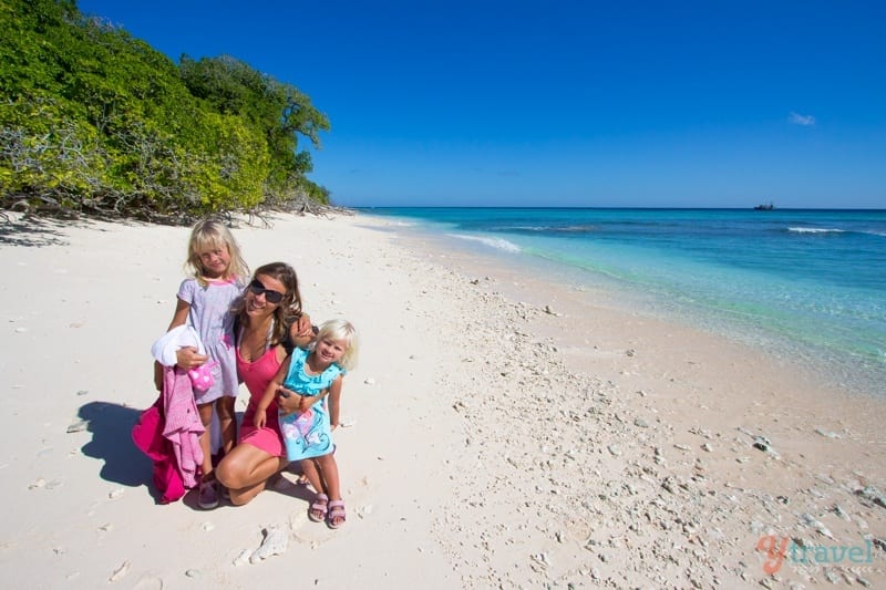 mother and kids posing on lady musgrave island beach