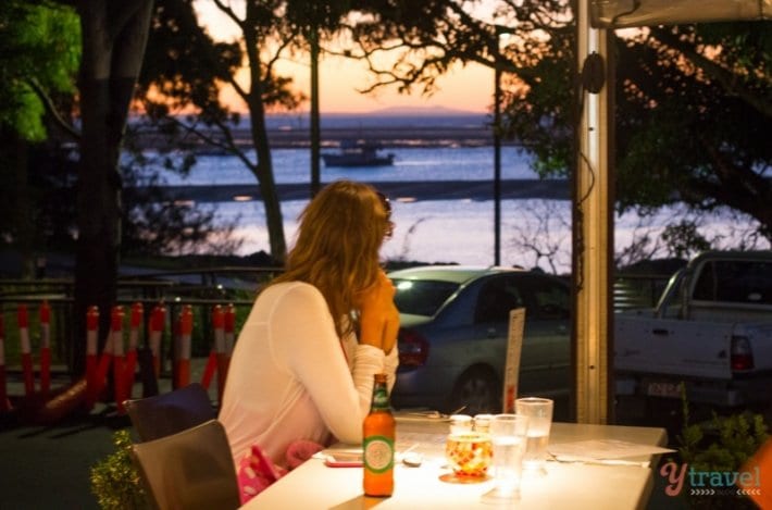 woman sitting at table at Tree Restaurant, Town of 1770, Queensland, Australia
