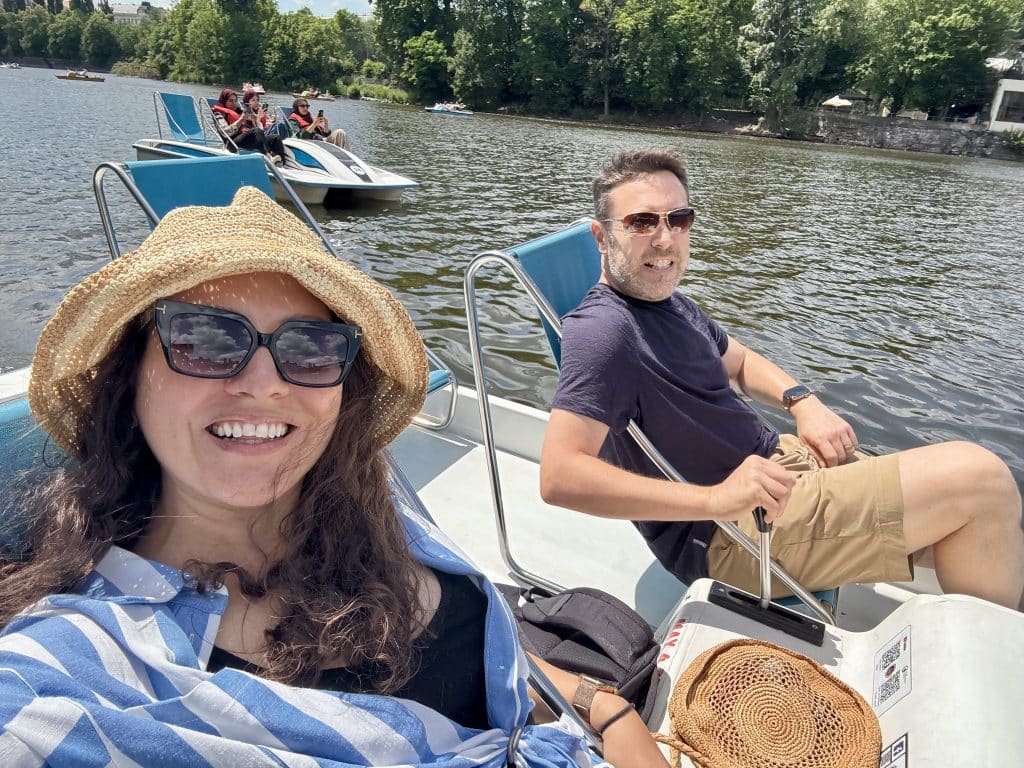 Kate and Charlie paddling in a paddle boat on the river.