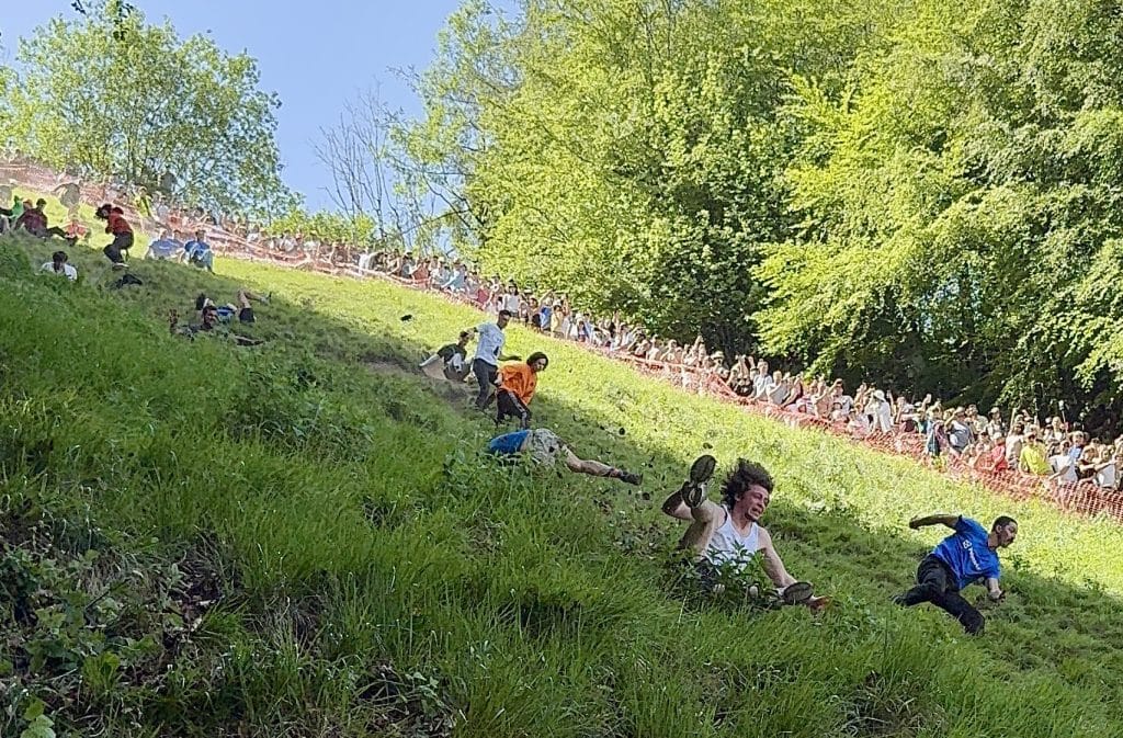 Several men racing down the hill with horror on their faces.