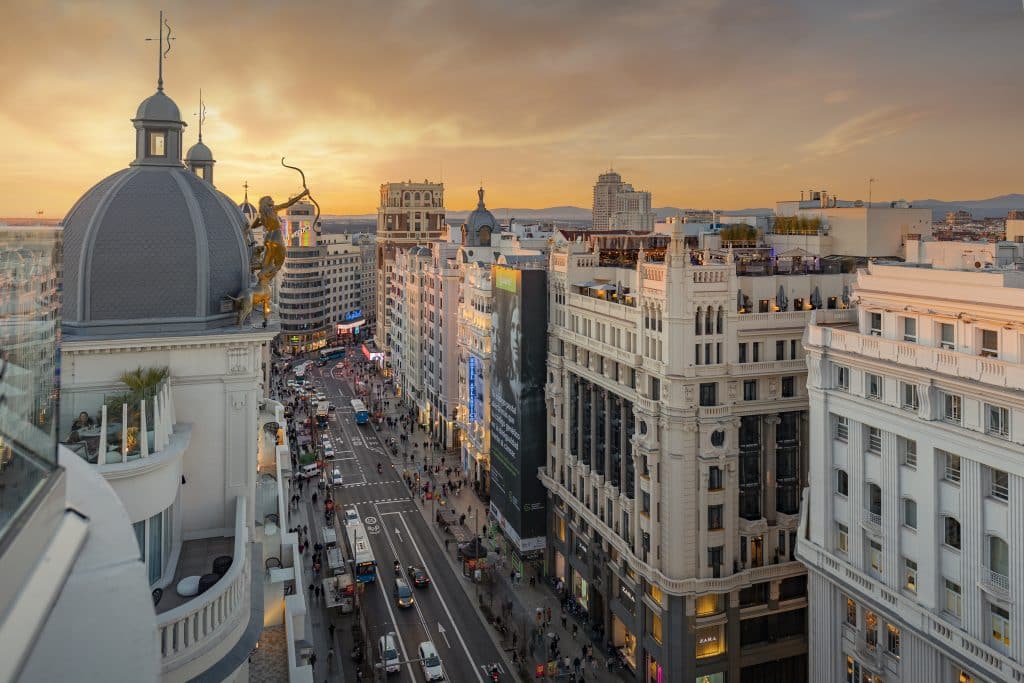 Aerial perspective of Gran Via street showing the iconic architecture and city traffic.