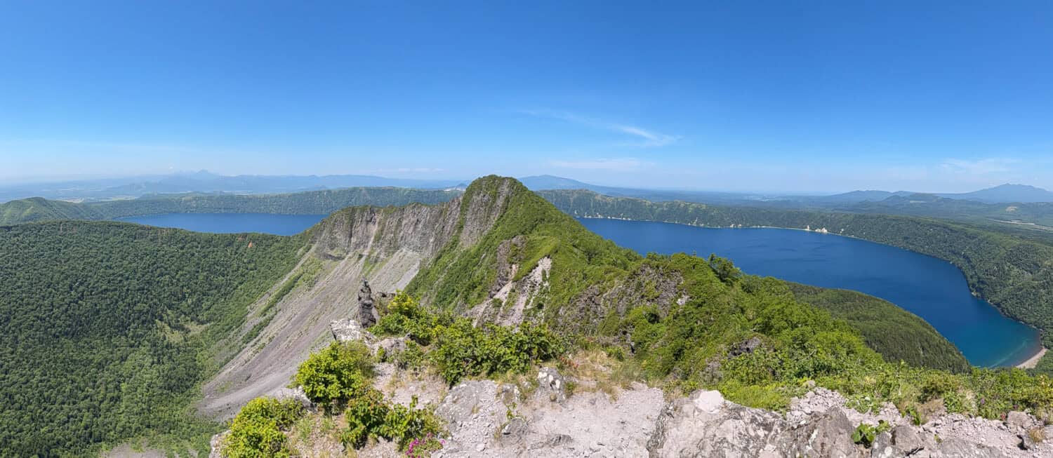 Panorama view of Lake Mashu from the Mt Mashu summit in Akan Mashu National Park in Hokkkaido, Japan.