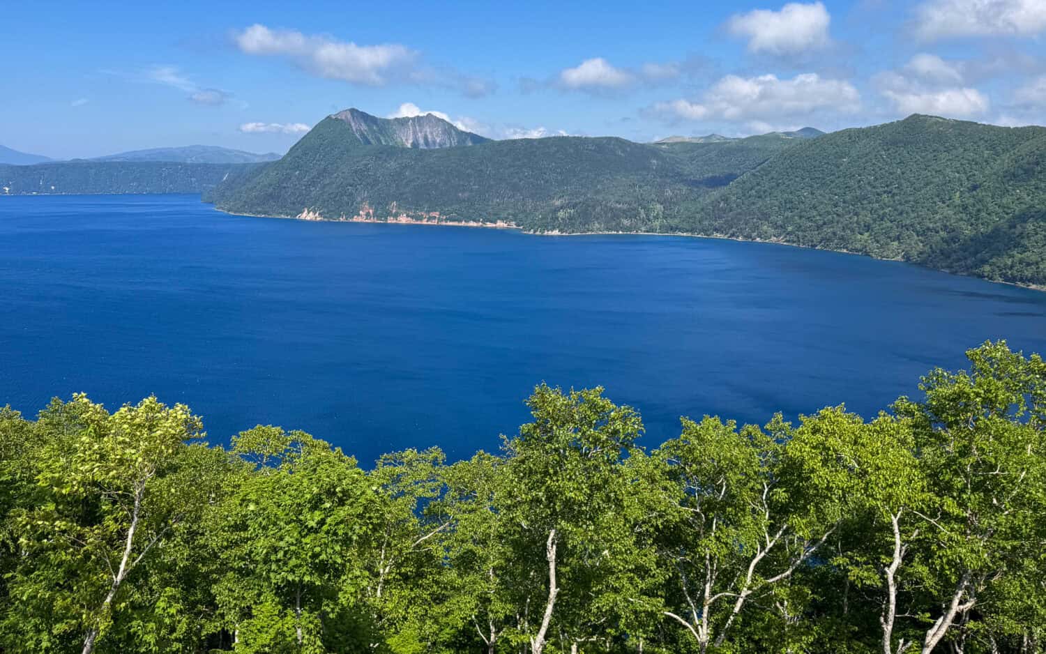 Lake Mashu on a sunny day from the Lake Mashu Observatory No 1 in Akan Mashu National Park in Hokkkaido, Japan.