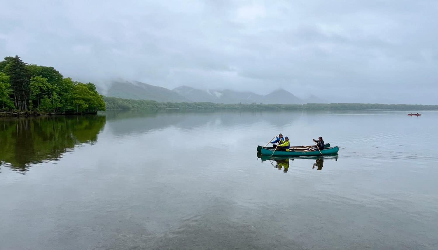 Canoeing on Lake Kussharo towards the Kushiro River headwaters.