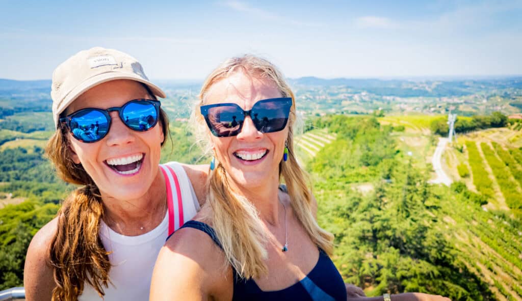 two ladies laughing with views of the Goriška Brda valley