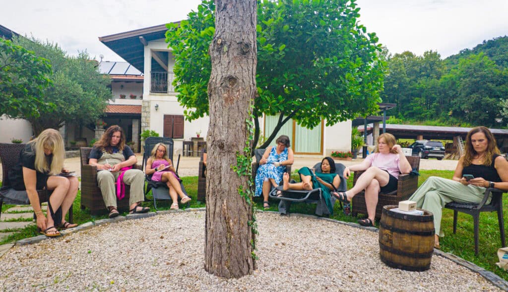 women sitting in circle around tree