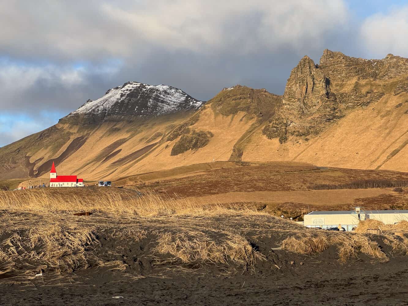 View of Vik church from Víkurfjara Black Sand Beach in Iceland.