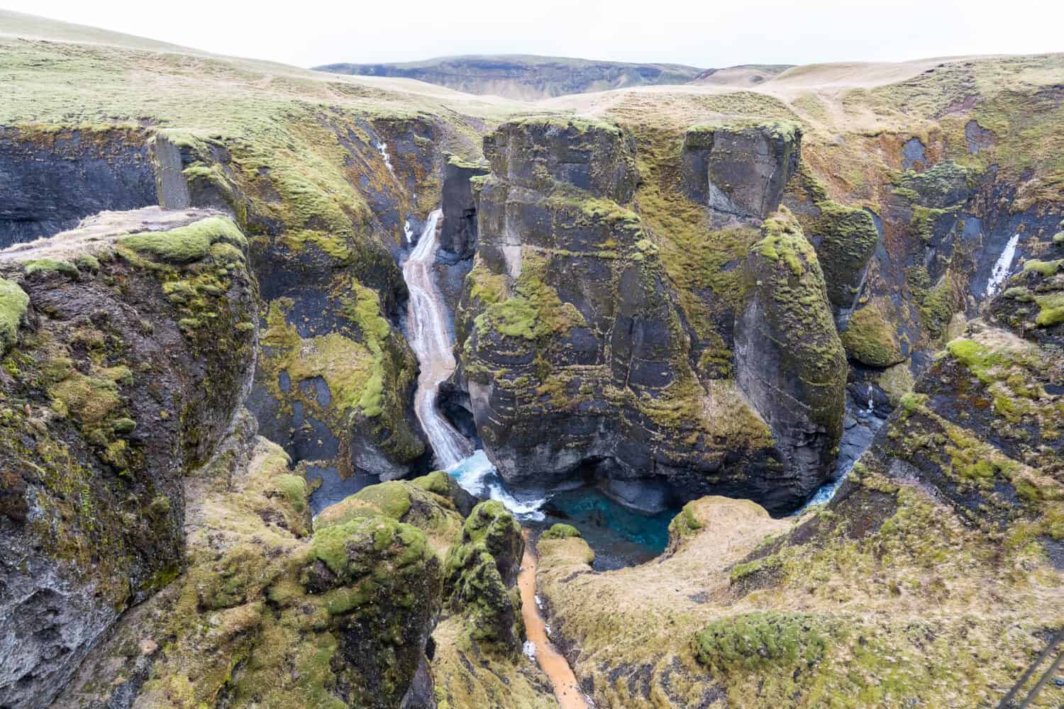 Fjaðrárgljúfur Canyon viewpoint with waterfall view.