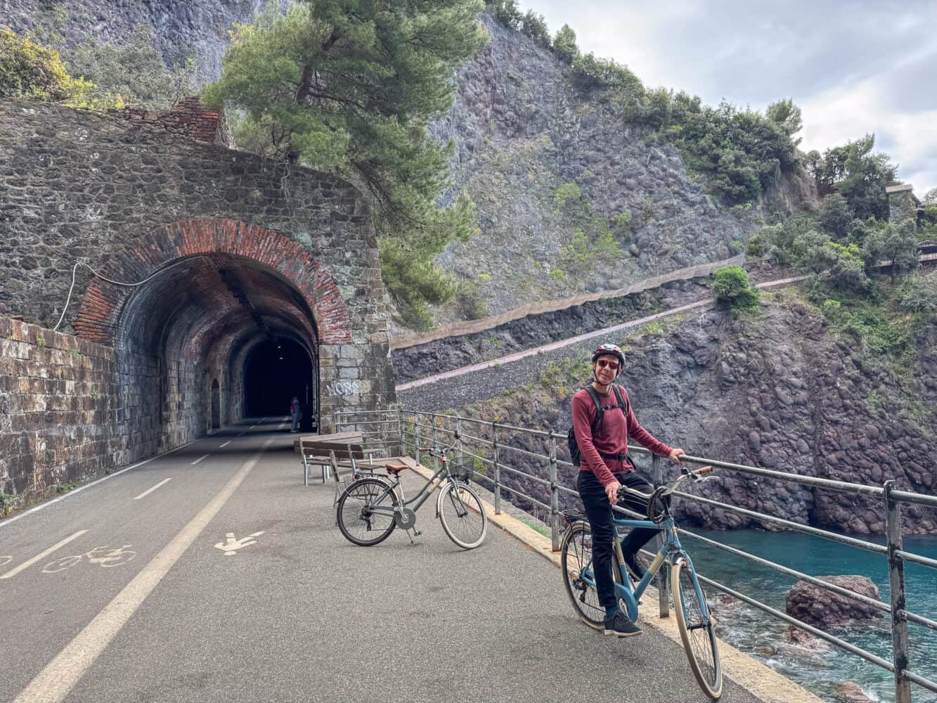 Biking through rail tunnels on the Pista Ciclopedonale Maremonti from Levanto to Framura in Italy.