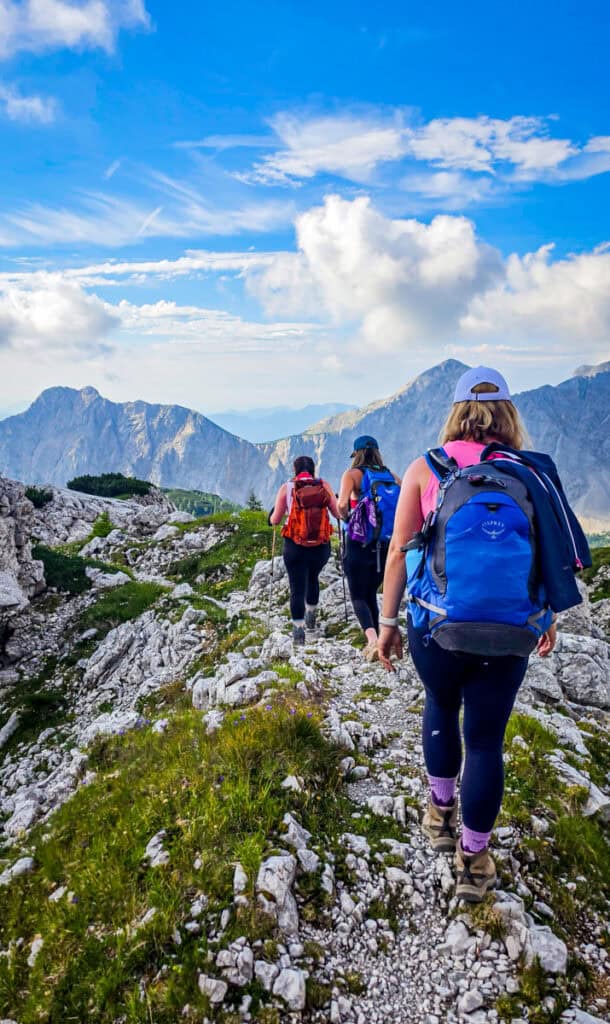 women hiking on mountain peaks