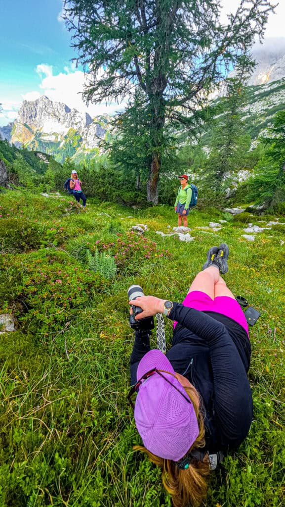 woman lying on grass taking the photo