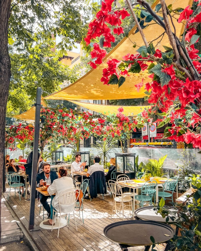 A chic outdoor terrace in the upscale Salamanca neighborhood of Madrid, perfect for the local "tardeo" afternoon drinks and social lifestyle.