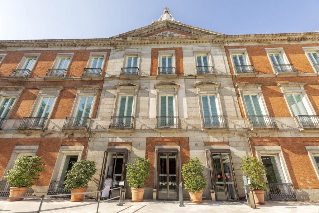 The neoclassical red-brick exterior of the Thyssen-Bornemisza National Museum, part of Madrid's Golden Triangle of Art.