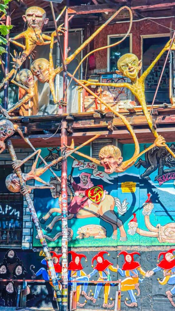 art sculptures and graffitied building walls at AKC Metelkova mesto