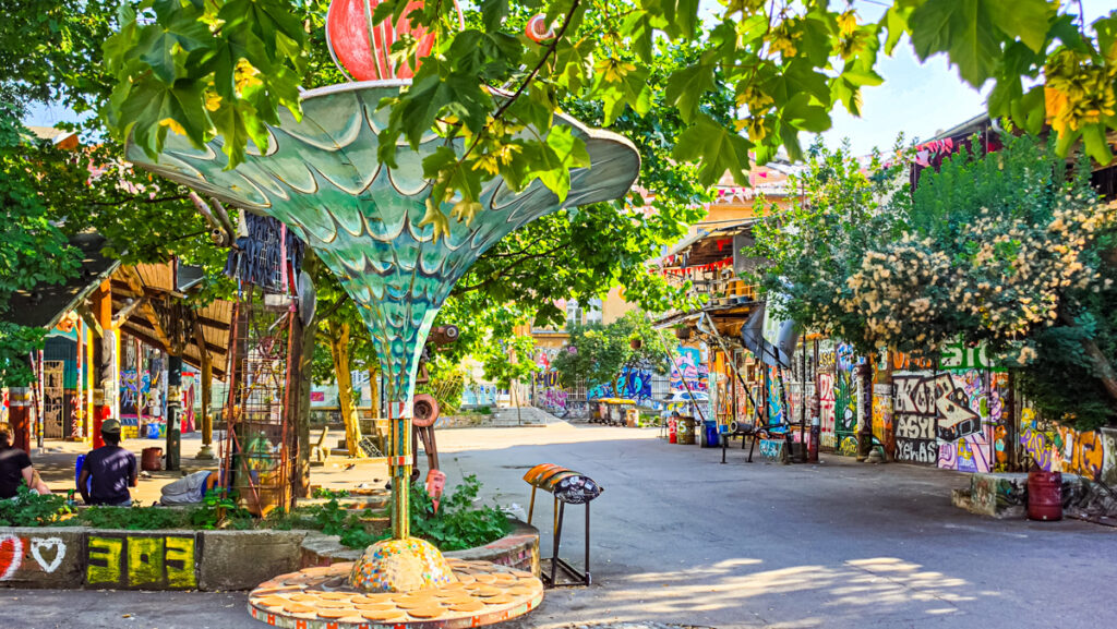 courtyard of AKC Metelkova mesto surrounded buildings covered in street art