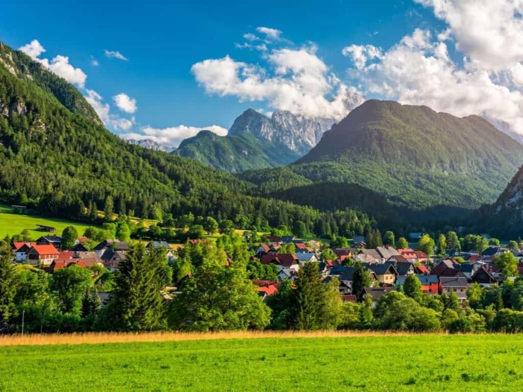Kranjska Gora town in Slovenia at summer with beautiful nature and mountains in the background.