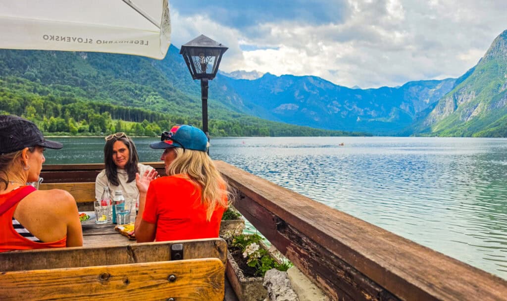 people sitting at restaurant by lake bohinj