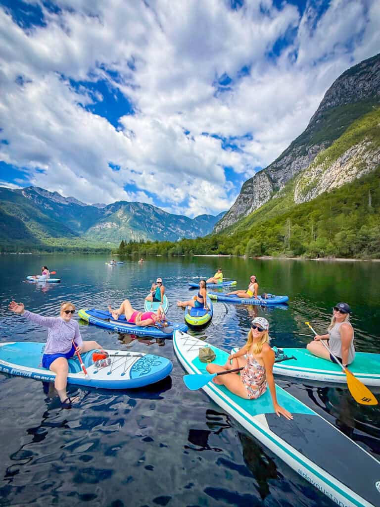 women paddleboarding lake bohinj