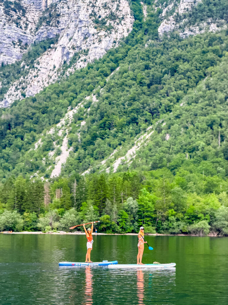 two girls on paddle boards lake bohinj