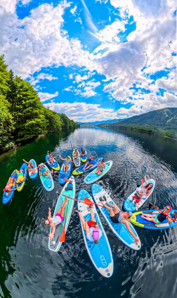 group of women on paddleboards lake bohinj