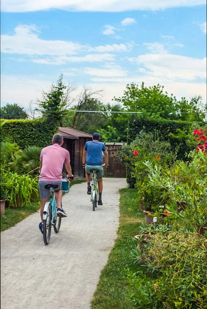 people on bikes riding through Ljubljana botanical gardens