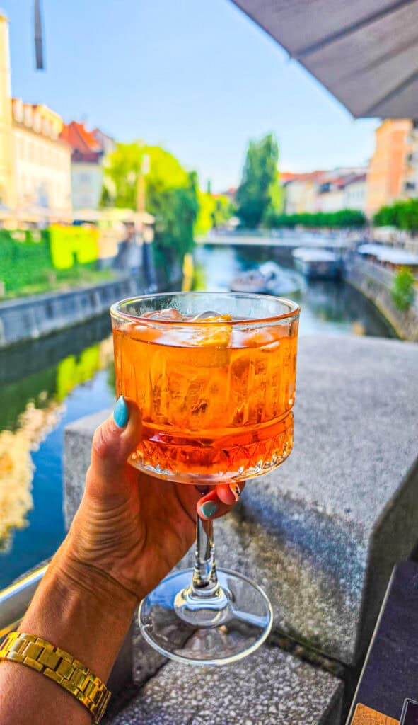 woman holding aperol spritz