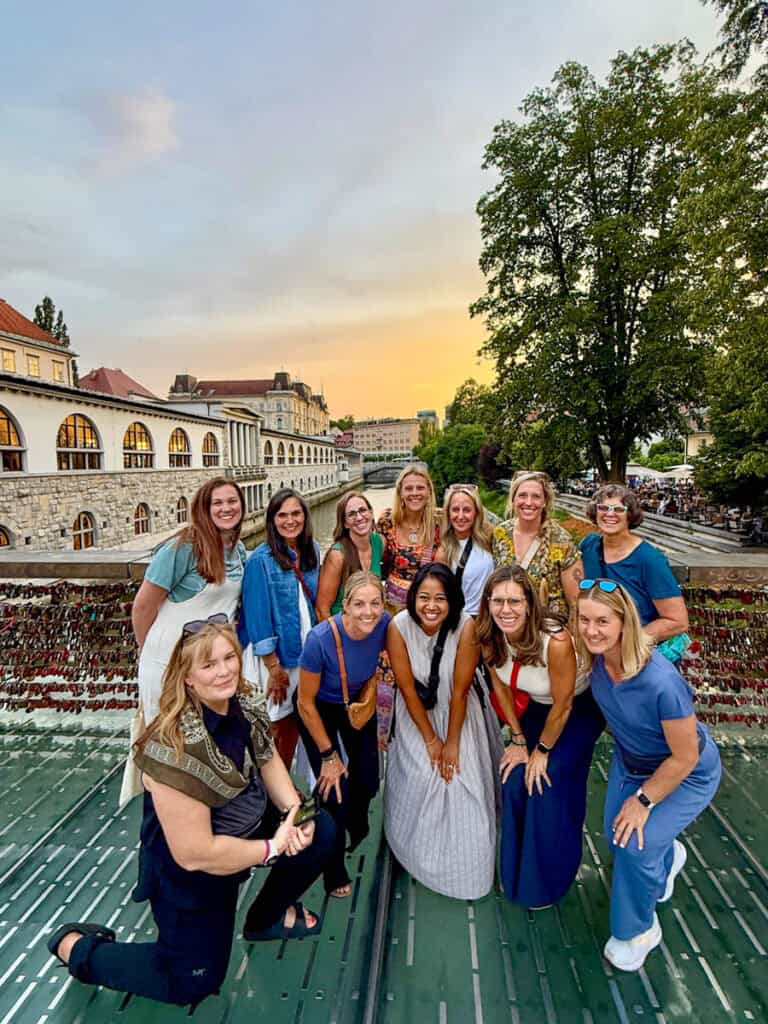 group of women taking photo on love bridge Ljubljana