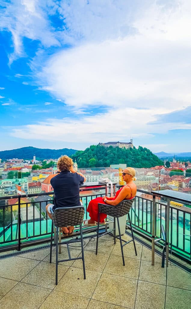 couple sitting on patio of Nebotičnik looking at view