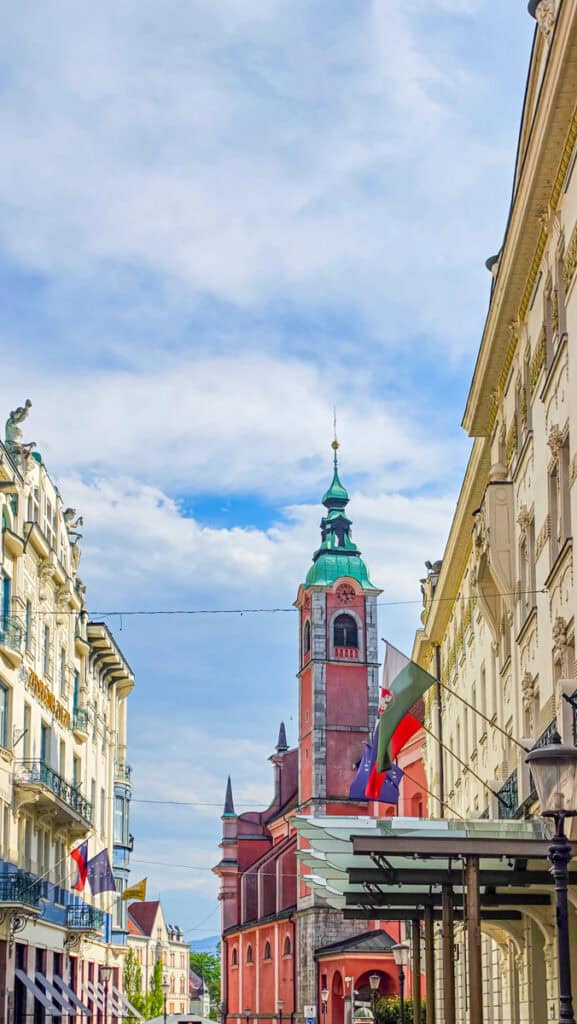 old buildings and pink steeple on streets of ljubljana