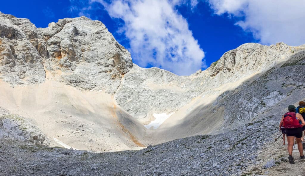 hikers looing at mt triglav summit from trail
