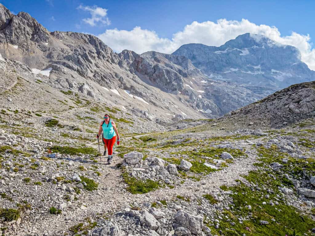woman walking in mt triglav trail with mountains