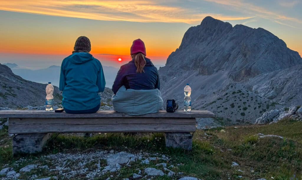 two women watching sunrise mt triglav