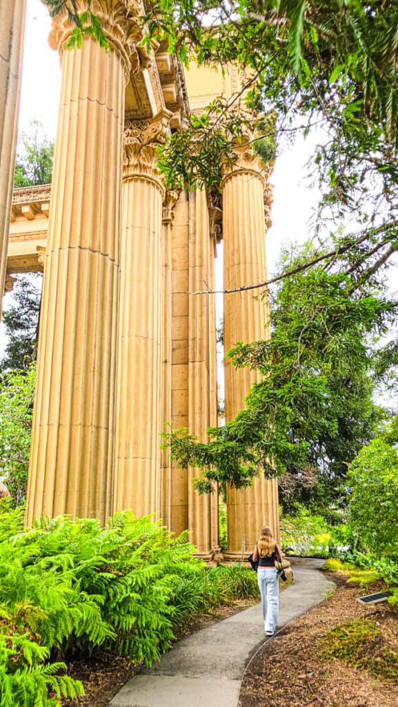 girl walking past palace of fine arts rotunda