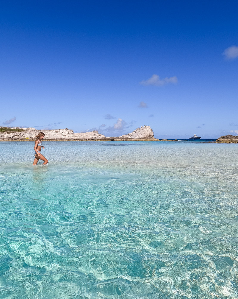 Young girl wading through water at a beach