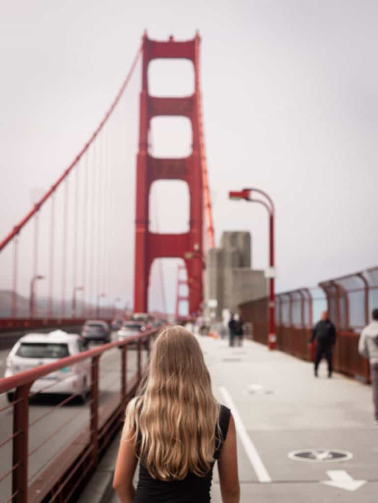 girl walking on golden gate bridge
