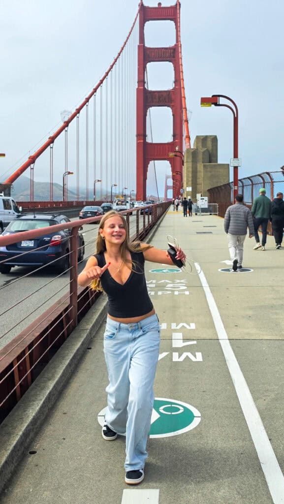 girl taking photo on golden gate bridge
