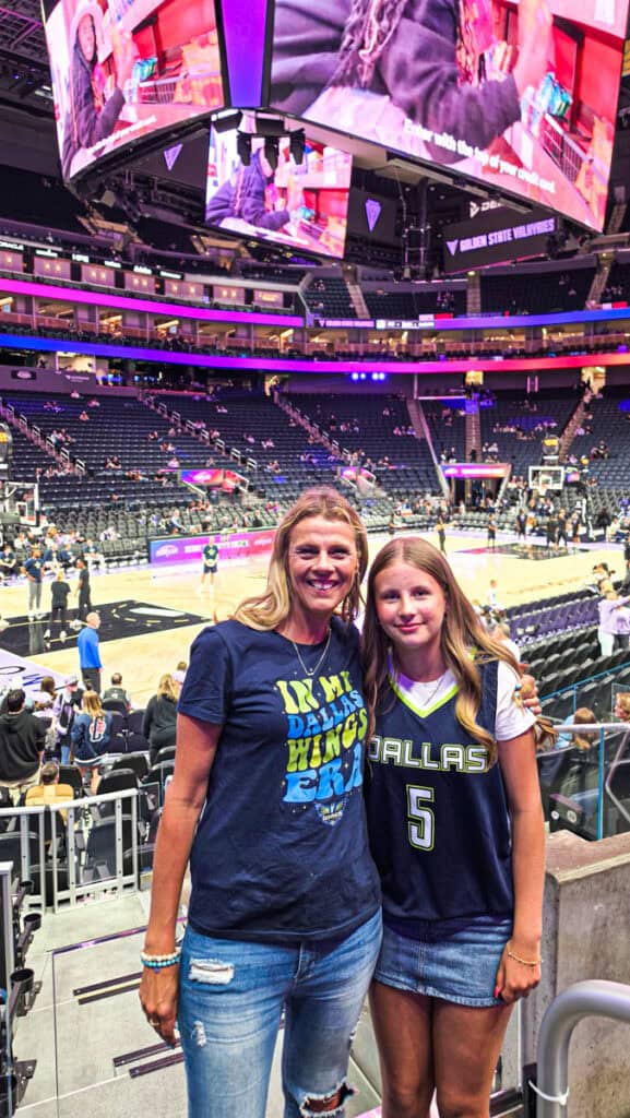 mother and daughter at wnba basketball game inside chase center in dallas wings gear