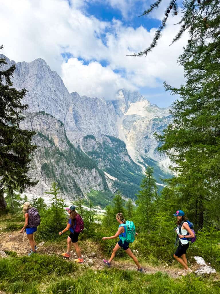 hikers going up Slemenova Špica trail with mountain range in backgroun