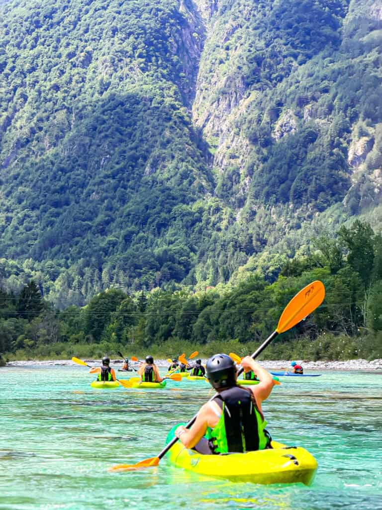 person kayaking on soca river