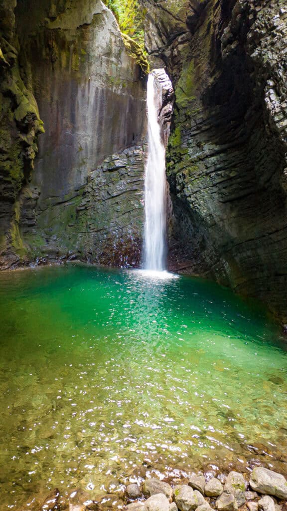 kozjak waterfall spilling into green pool