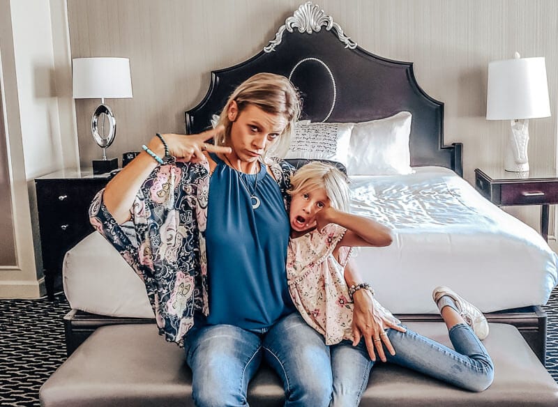 people sitting on a hotel bed
